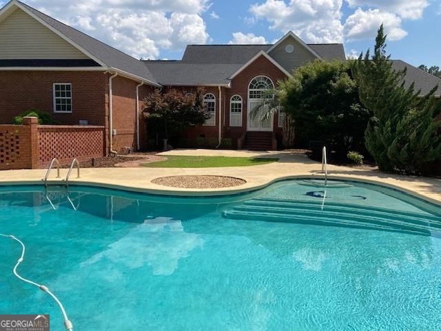 550 Masters Cir, Dublin, GA 31021 - swimming pool featuring a patio area