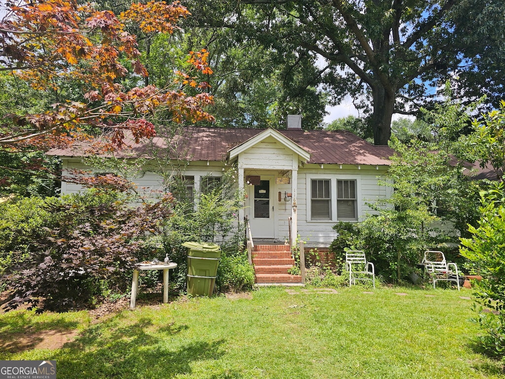 116 Mara St, Carrollton, GA 30117 - bungalow-style home with a front yard and a chimney
