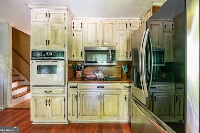 1025 Northridge Rd, Ball Ground, GA 30107 - kitchen with oven, stainless steel microwave, black electric cooktop, and cream cabinets