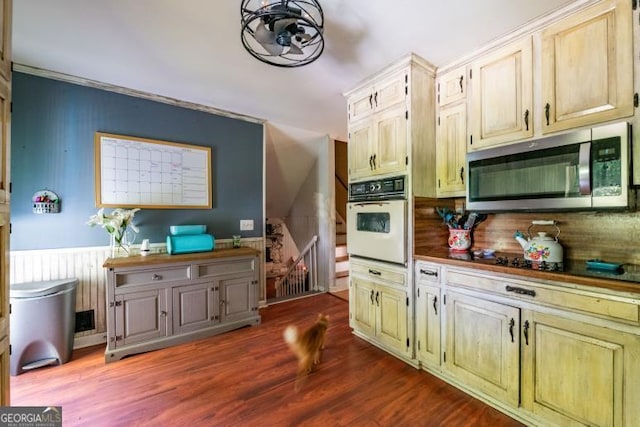 1025 Northridge Rd, Ball Ground, GA 30107 - kitchen with stainless steel microwave, white oven, decorative backsplash, and dark wood-style flooring