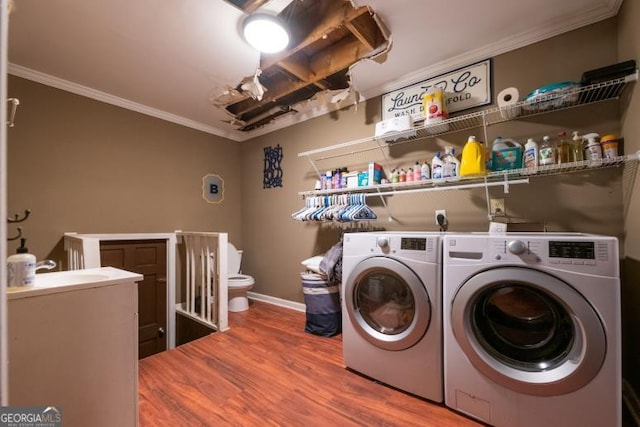 1025 Northridge Rd, Ball Ground, GA 30107 - laundry room with ornamental molding, washing machine and clothes dryer, and wood finished floors