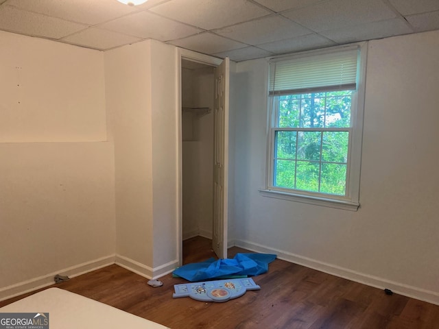 1025 Northridge Rd, Ball Ground, GA 30107 - unfurnished bedroom featuring a drop ceiling, wood finished floors, and a closet