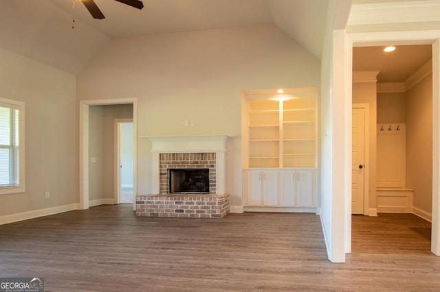 776 Fleeting Way, Monroe, GA 30655 - unfurnished living room with a ceiling fan, lofted ceiling, wood finished floors, a fireplace, and built in shelves
