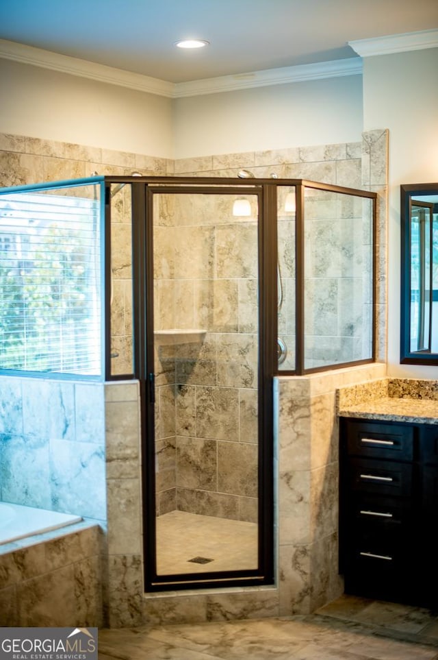 776 Fleeting Way, Monroe, GA 30655 - full bathroom featuring vanity, a stall shower, crown molding, and a relaxing tiled tub