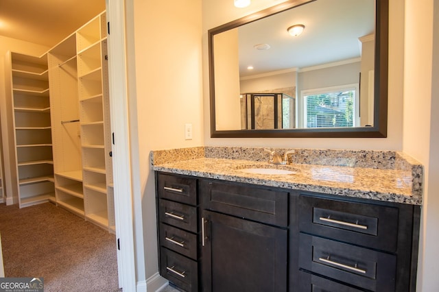 776 Fleeting Way, Monroe, GA 30655 - bathroom with vanity, ornamental molding, a shower stall, and a walk in closet