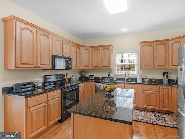 17 Rocky Mountain Pass, Adairsville, GA 30103 - kitchen with black appliances, light wood-type flooring, dark stone counters, a center island, and recessed lighting