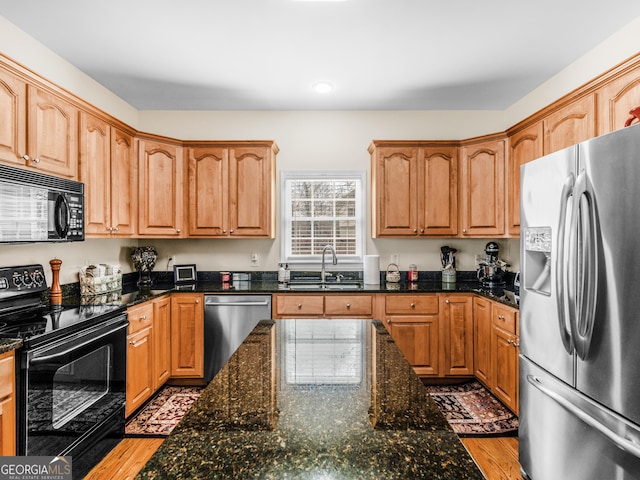 17 Rocky Mountain Pass, Adairsville, GA 30103 - kitchen featuring black appliances, light wood-type flooring, dark stone countertops, and recessed lighting
