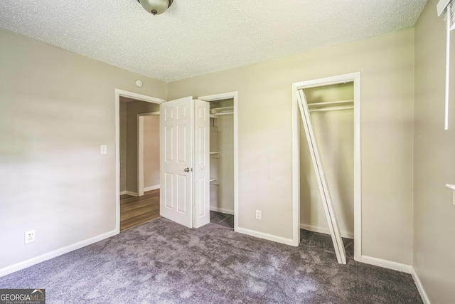 6770 Burkhead Dr, Union City, GA 30291 - unfurnished bedroom with two closets, carpet, and a textured ceiling