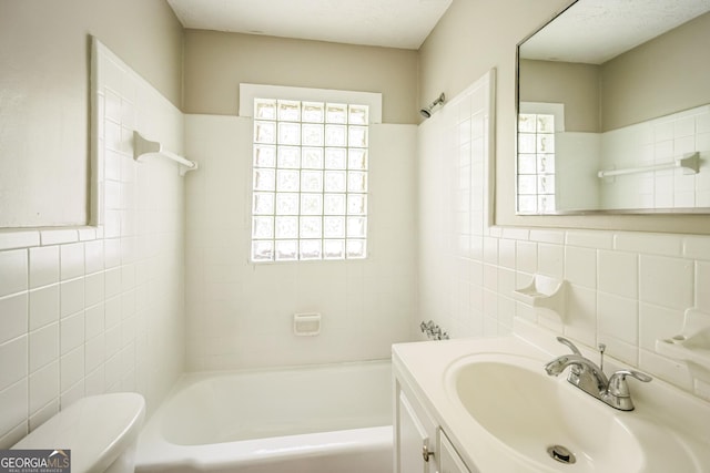 6770 Burkhead Dr, Union City, GA 30291 - bathroom with tile walls, vanity, plenty of natural light, and shower / bath combination