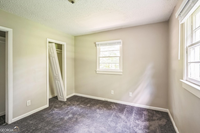 6770 Burkhead Dr, Union City, GA 30291 - unfurnished bedroom with dark colored carpet and a textured ceiling
