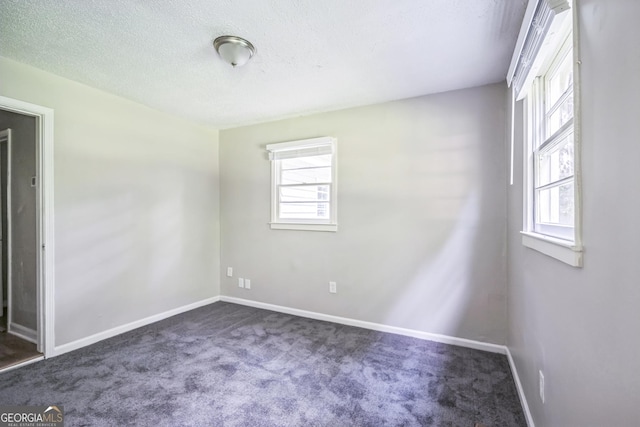 6770 Burkhead Dr, Union City, GA 30291 - unfurnished room featuring dark carpet and a textured ceiling
