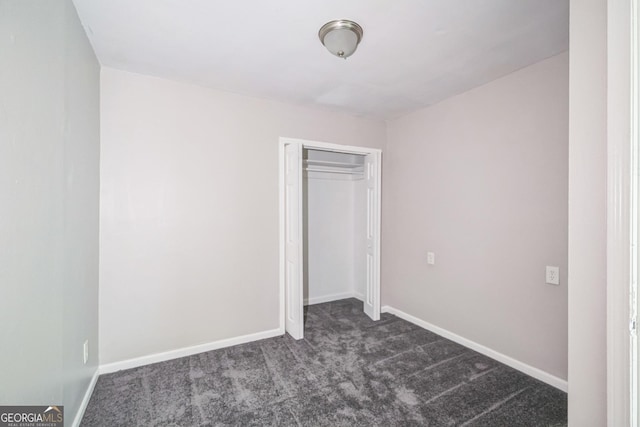 6770 Burkhead Dr, Union City, GA 30291 - unfurnished bedroom featuring dark colored carpet and a closet