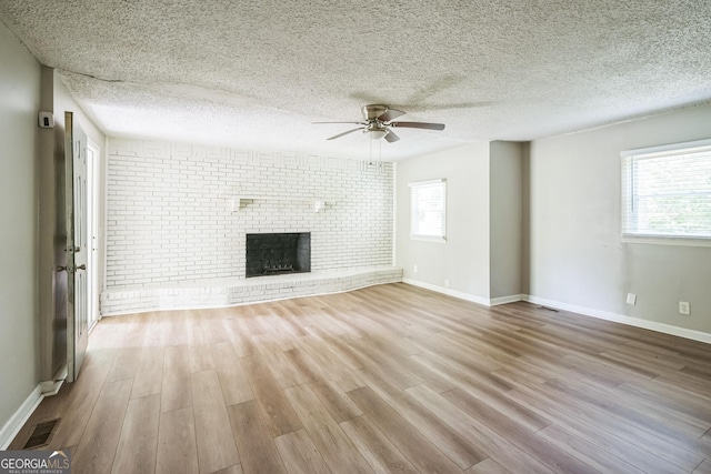 6770 Burkhead Dr, Union City, GA 30291 - unfurnished living room with a ceiling fan, wood finished floors, plenty of natural light, and a textured ceiling
