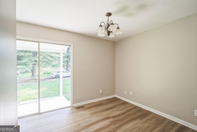 6770 Burkhead Dr, Union City, GA 30291 - unfurnished room featuring a chandelier and wood finished floors
