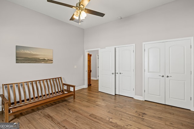 124 E Broad St, Newnan, GA 30263 - bedroom with multiple closets, wood finished floors, and ceiling fan