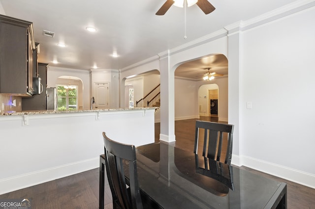 416 Fairway Dr, Acworth, GA 30101 - dining space with ceiling fan, arched walkways, crown molding, dark wood-type flooring, and stairs
