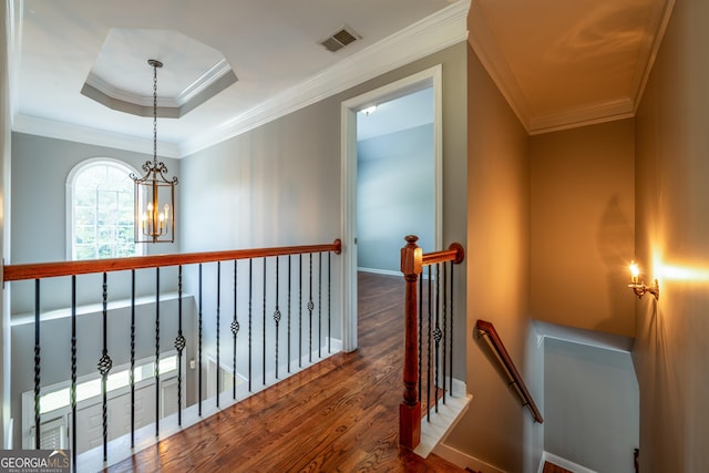 4311 Hampton Mill Pkwy, Douglasville, GA 30135 - hall featuring an upstairs landing, wood finished floors, a chandelier, and crown molding