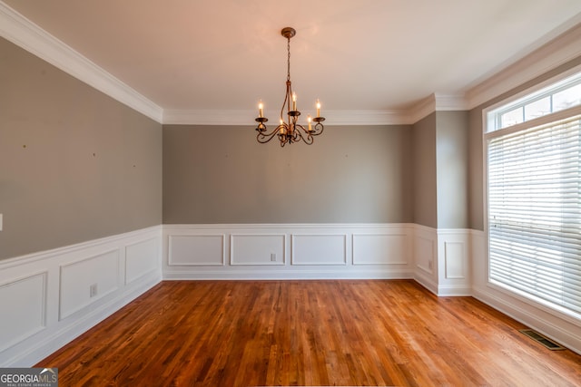 4311 Hampton Mill Pkwy, Douglasville, GA 30135 - empty room with a chandelier, ornamental molding, wood finished floors, and a wainscoted wall
