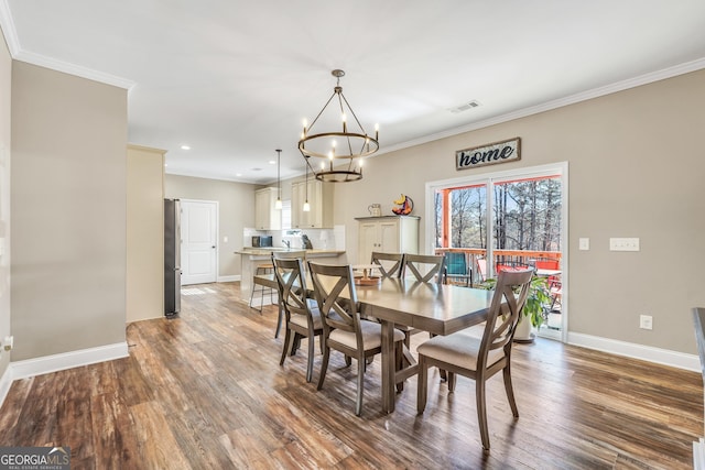 230 Thorpe Rd, Jackson, GA 30233 - dining area with a chandelier, wood finished floors, crown molding, and recessed lighting