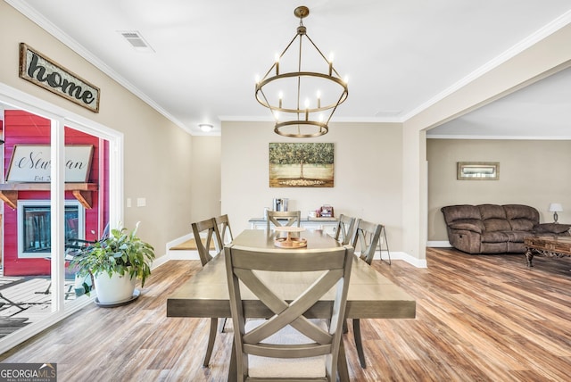 230 Thorpe Rd, Jackson, GA 30233 - dining space featuring wood finished floors, a chandelier, and crown molding