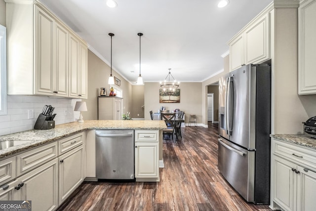 230 Thorpe Rd, Jackson, GA 30233 - kitchen with appliances with stainless steel finishes, a peninsula, dark wood-style floors, crown molding, and backsplash