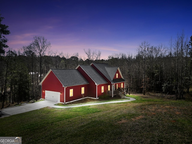 230 Thorpe Rd, Jackson, GA 30233 - view of front facade featuring concrete driveway, a front yard, a garage, and a wooded view
