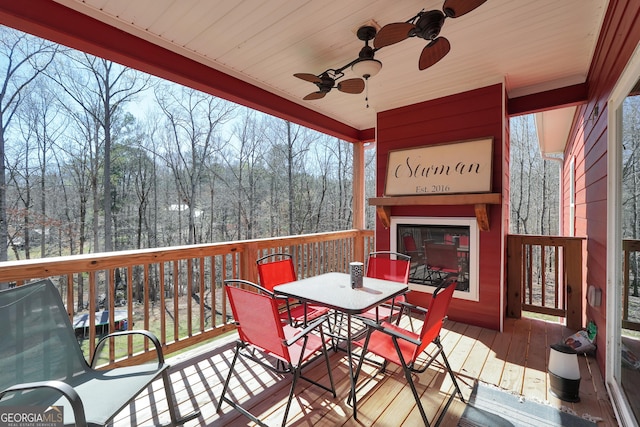 230 Thorpe Rd, Jackson, GA 30233 - wooden terrace with ceiling fan, outdoor dining area, and a view of trees