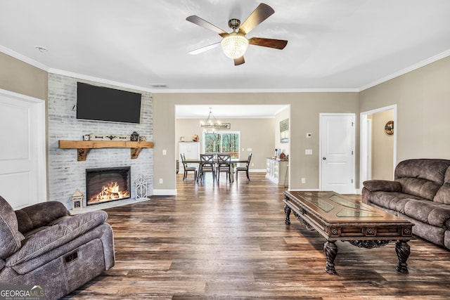 230 Thorpe Rd, Jackson, GA 30233 - living room with dark wood-style floors, a fireplace, ceiling fan, crown molding, and a chandelier