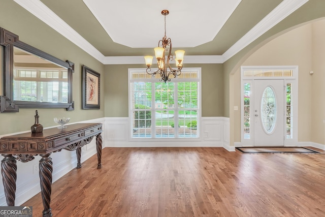 204 Carmell Ct, Mcdonough, GA 30252 - foyer featuring a chandelier, wood finished floors, healthy amount of natural light, wainscoting, and a decorative wall