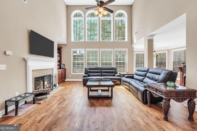 204 Carmell Ct, Mcdonough, GA 30252 - living room with ceiling fan, a high ceiling, wood finished floors, and a premium fireplace