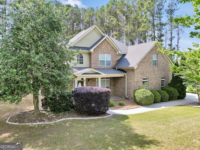 204 Carmell Ct, Mcdonough, GA 30252 - craftsman inspired home featuring a front lawn, brick siding, roof with shingles, and a porch
