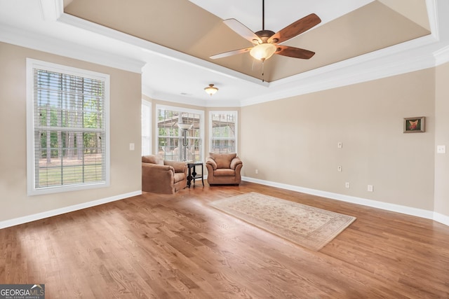 204 Carmell Ct, Mcdonough, GA 30252 - living area with a tray ceiling, crown molding, a ceiling fan, and wood finished floors