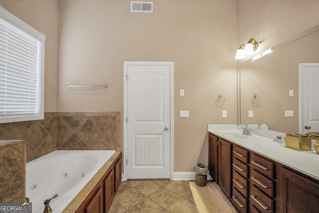204 Carmell Ct, Mcdonough, GA 30252 - full bathroom with vanity, a jetted tub, and tile patterned floors