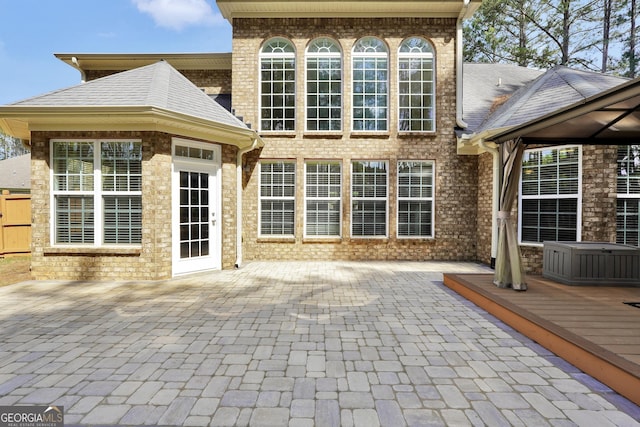 204 Carmell Ct, Mcdonough, GA 30252 - rear view of property with a patio, a shingled roof, a wooden deck, and brick siding