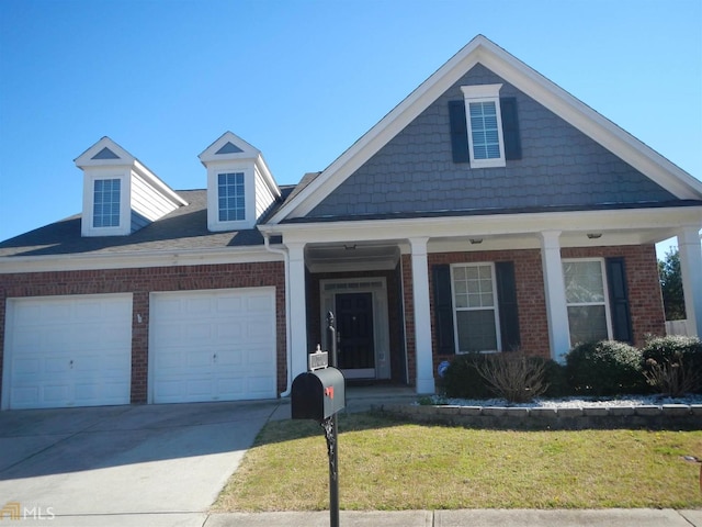 3607 Wood Point Way, Gainesville, GA 30507 - view of front facade with a garage, covered porch, driveway, brick siding, and a front yard
