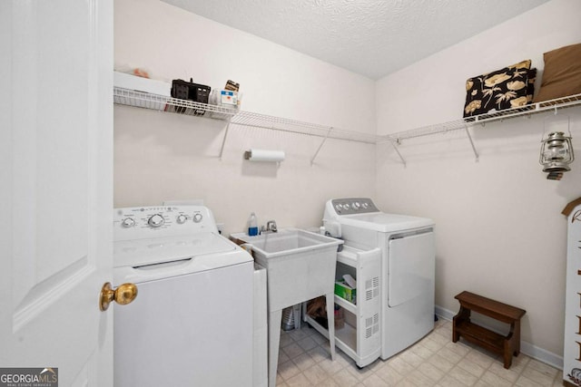 3076 Harris Mill Ct, Duluth, GA 30096 - laundry room featuring washer and clothes dryer, light floors, and a textured ceiling