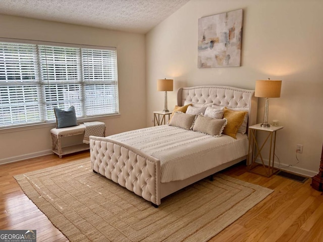 3076 Harris Mill Ct, Duluth, GA 30096 - bedroom featuring light wood finished floors and a textured ceiling