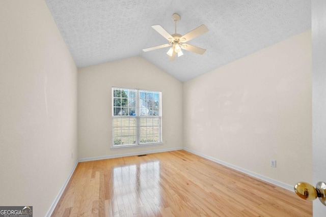 3076 Harris Mill Ct, Duluth, GA 30096 - unfurnished room featuring light wood-style floors, a textured ceiling, vaulted ceiling, and ceiling fan