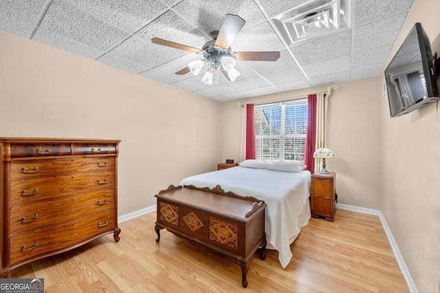 3076 Harris Mill Ct, Duluth, GA 30096 - bedroom with light wood-style floors, a ceiling fan, and a drop ceiling