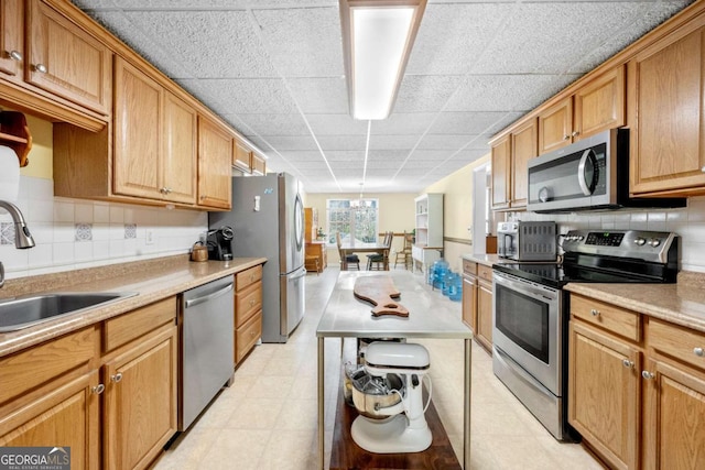 3076 Harris Mill Ct, Duluth, GA 30096 - kitchen featuring appliances with stainless steel finishes, light countertops, decorative backsplash, and light flooring
