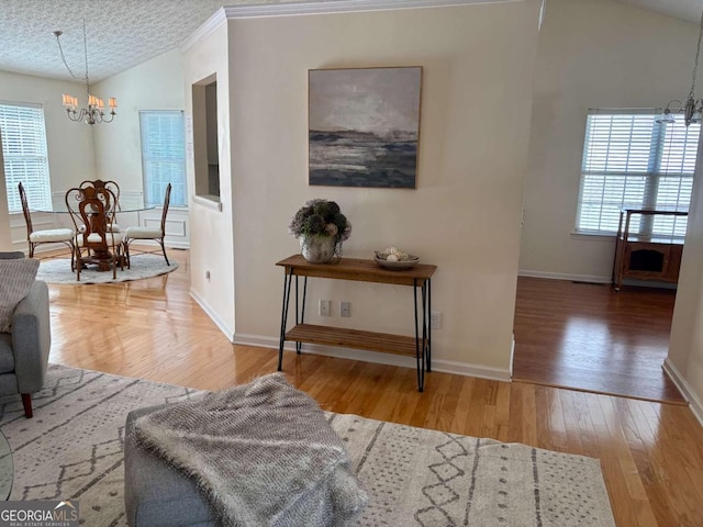 3076 Harris Mill Ct, Duluth, GA 30096 - living area featuring a chandelier, vaulted ceiling, and wood finished floors