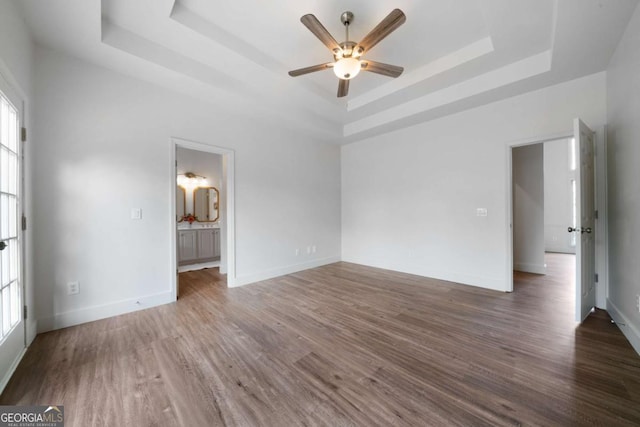 3047 Standing Rock Ct, Lithia Springs, GA 30122 - unfurnished room featuring a raised ceiling, a ceiling fan, healthy amount of natural light, and wood finished floors