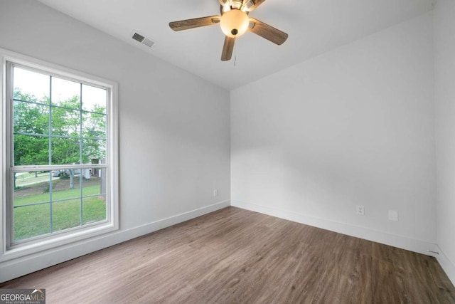 3047 Standing Rock Ct, Lithia Springs, GA 30122 - unfurnished room with healthy amount of natural light, wood finished floors, and a ceiling fan