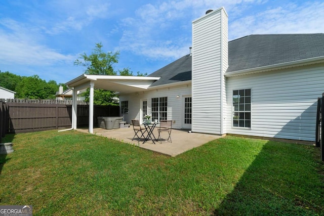 3047 Standing Rock Ct, Lithia Springs, GA 30122 - back of property featuring a patio, a chimney, a hot tub, and a shingled roof