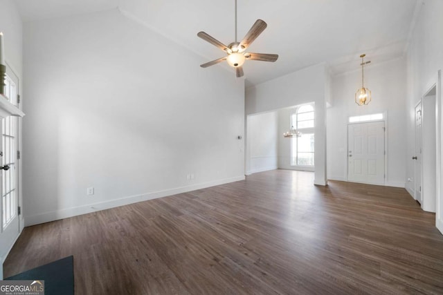 3047 Standing Rock Ct, Lithia Springs, GA 30122 - unfurnished living room featuring a chandelier, wood finished floors, ceiling fan, and high vaulted ceiling