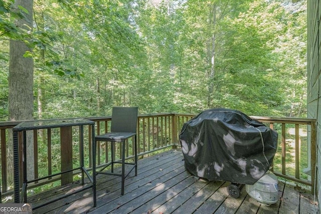 104 Buck Run E, Dahlonega, GA 30533 - wooden deck featuring grilling area and a view of trees