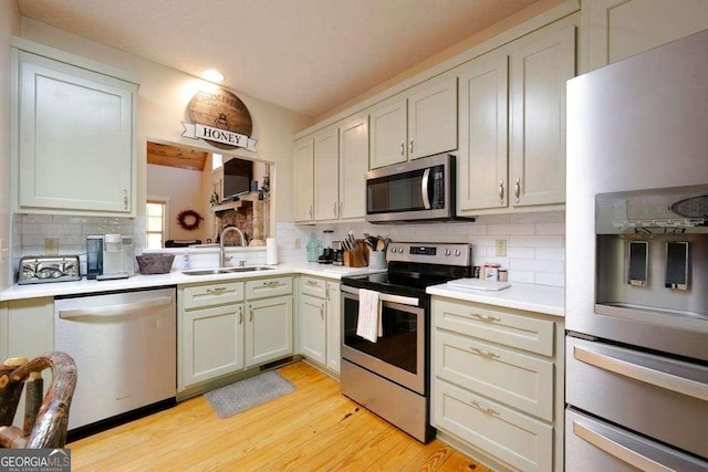 104 Buck Run E, Dahlonega, GA 30533 - kitchen with stainless steel appliances, light countertops, tasteful backsplash, light wood-style flooring, and recessed lighting