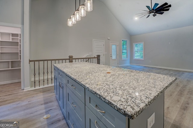 48 Bluejay Ct, Monticello, GA 31064 - kitchen with a center island, light wood-type flooring, high vaulted ceiling, ceiling fan, and hanging light fixtures