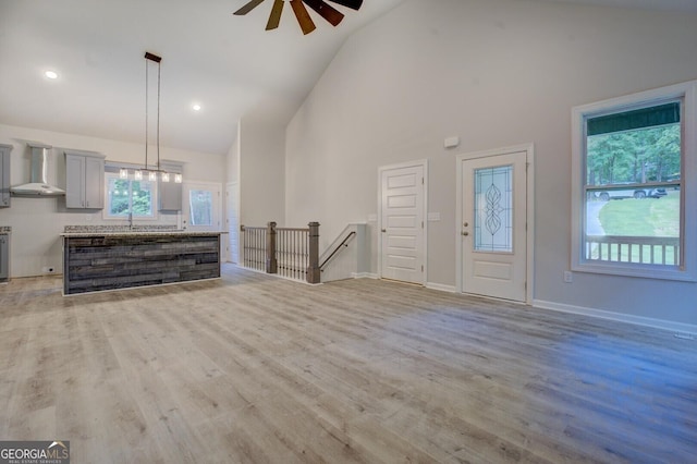 48 Bluejay Ct, Monticello, GA 31064 - unfurnished living room with ceiling fan, high vaulted ceiling, and light wood-style flooring