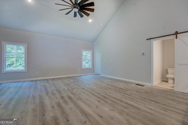 48 Bluejay Ct, Monticello, GA 31064 - unfurnished room with a barn door, high vaulted ceiling, ceiling fan, light wood-style floors, and recessed lighting